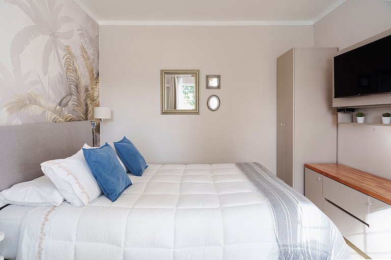 Room with private bathroom and view of a garden.
