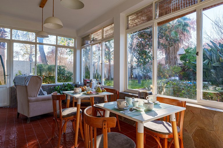 Room with private bathroom and view of a garden.
