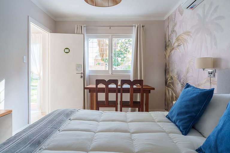 Room with private bathroom and view of a garden.