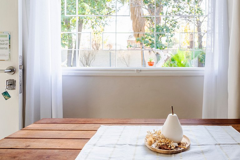 Room with private bathroom and view of a garden.